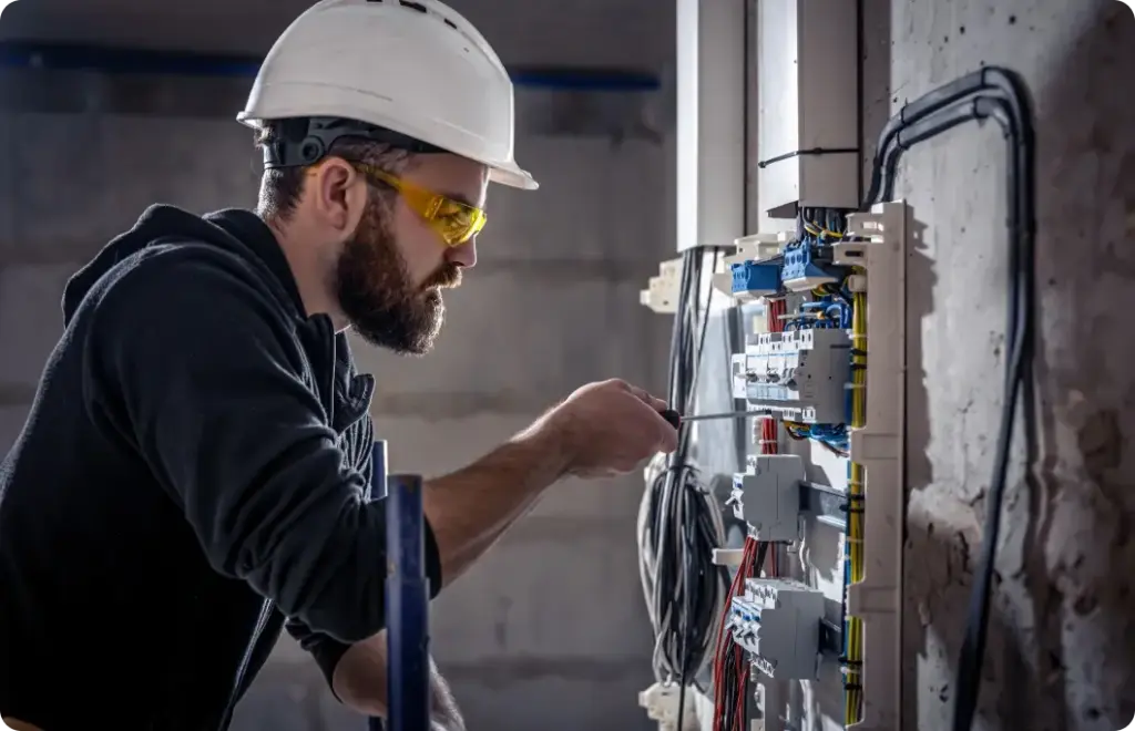 Electrician uses a tool to reset electrical components